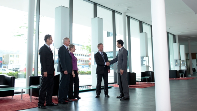 Employee and customer shaking hands in the lobby